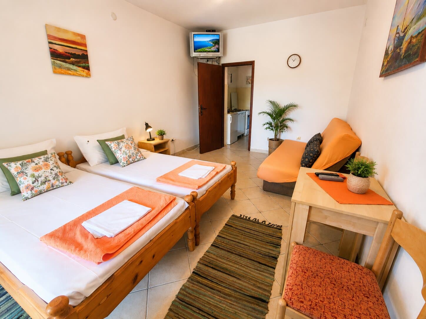 The studio room — twin beds, desk and kitchenette through the door